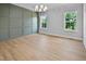 Open dining room featuring hardwood floors, large windows, and paneled accent wall at 83 Nottoway Lane, Wendell, NC 27591