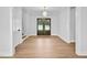 Bright entryway featuring wood-look flooring, white walls, stairs, and dark wooden front doors at 83 Nottoway Lane, Wendell, NC 27591