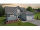 Charming single-Gathering home showcasing a manicured lawn, attached garage, and inviting front porch at 83 Nottoway Lane, Wendell, NC 27591
