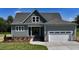 Inviting two-story home with a gray roof, attached garage, manicured lawn, and lovely landscaping at 83 Nottoway Lane, Wendell, NC 27591