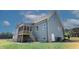 The backyard view of the house features gray siding, a screened porch, and a well-manicured lawn at 83 Nottoway Lane, Wendell, NC 27591