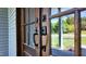 Close-up of the wood double doors featuring elegant hardware and quality craftsmanship at 83 Nottoway Lane, Wendell, NC 27591