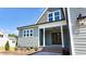 Charming home featuring a covered front entrance with craftsman details, a brick landing, and verdant landscaping at 83 Nottoway Lane, Wendell, NC 27591