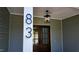 Close-up of home's entrance with address, stylish lantern, and wood double doors at 83 Nottoway Lane, Wendell, NC 27591