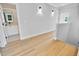Welcoming hallway with light hardwood flooring and a view into a well-lit bathroom at 83 Nottoway Lane, Wendell, NC 27591