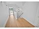 Inviting hallway with hardwood floors leads to stairs and an outdoor view at 83 Nottoway Lane, Wendell, NC 27591
