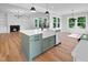 Spacious kitchen island featuring a farmhouse sink, stainless steel dishwasher, and dining area at 83 Nottoway Lane, Wendell, NC 27591