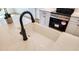 Bright kitchen featuring a farmhouse sink with a black faucet and white countertops with a subtle marble pattern at 83 Nottoway Lane, Wendell, NC 27591