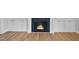 Cozy living room featuring hardwood floors, white built-in cabinets, and a fireplace at 83 Nottoway Lane, Wendell, NC 27591