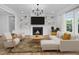 Bright living room with fireplace, custom built-ins, hardwood floors, and large windows for plenty of natural light at 83 Nottoway Lane, Wendell, NC 27591