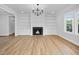 Bright living room featuring hardwood floors, white built-in cabinets, and a fireplace at 83 Nottoway Lane, Wendell, NC 27591