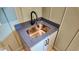 Mudroom sink featuring a bronze faucet, gray countertops, and shaker-style cabinets at 83 Nottoway Lane, Wendell, NC 27591