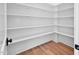 Pantry features white shelving and wood floor at 83 Nottoway Lane, Wendell, NC 27591