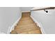 Staircase featuring light hardwood steps and white risers adding a clean and modern look at 83 Nottoway Lane, Wendell, NC 27591