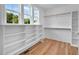 Spacious walk-in closet with built-in shelving and great natural light from the large window at 83 Nottoway Lane, Wendell, NC 27591