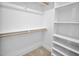 Bright walk-in closet featuring hardwood flooring and custom shelving, providing ample storage space at 83 Nottoway Lane, Wendell, NC 27591
