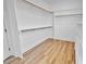 Bright walk-in closet featuring hardwood flooring and custom shelving, providing ample storage space at 83 Nottoway Lane, Wendell, NC 27591