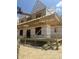 A construction site showing the building of a new home's frame and decking on a sunny day at 975 Wilbon Rd, Holly Springs, NC 27540