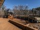 Wooden backyard deck featuring outdoor kitchen with views of the lush greenery at 101 Rutherglen Dr, Cary, NC 27511