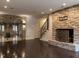 This living room features a stone accent wall, modern hardwood floors, and recessed lighting at 101 Rutherglen Dr, Cary, NC 27511