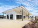 Exterior of the community clubhouse featuring an open-air covered space and lush landscaping at 1012 Channel Drop Lp, Zebulon, NC 27597