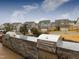 Outdoor kitchen featuring stone accents, stainless steel grills, and a view of the neighborhood homes at 1012 Channel Drop Lp, Zebulon, NC 27597
