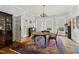 Elegant dining room with a chandelier, hardwood floors, and a traditional area rug at 1014 Shepherd St, Durham, NC 27707