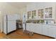 Bright kitchen with white cabinets, glass-front display shelves, and hardwood flooring at 1014 Shepherd St, Durham, NC 27707