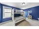 Blue bedroom featuring a white bunk bed and a decorative monogram for a cozy atmosphere at 1016 Traditions Meadow Dr, Wake Forest, NC 27587