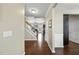 Warm foyer with hardwood floors, staircase, and entry to the living room featuring a cozy fireplace at 1016 Traditions Meadow Dr, Wake Forest, NC 27587