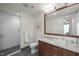 Bathroom featuring a marble vanity and a large mirror, with a walk-in shower in the background at 110 N Corcoran St # 2304, Durham, NC 27701