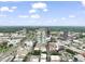 A cityscape view with a modern residential high-rise with many trees and clear skies at 110 N Corcoran St # 2304, Durham, NC 27701
