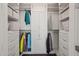 Well-organized walk-in closet featuring custom shelving, drawers, and ample storage space for clothes and accessories at 110 N Corcoran St # 2304, Durham, NC 27701