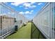 Rooftop dog run featuring artificial grass, bench, and pet waste station for residents to enjoy with their furry friends at 110 N Corcoran St # 2304, Durham, NC 27701