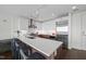 Modern kitchen with stainless steel appliances, sleek white cabinetry, and a large center island at 110 N Corcoran St # 2304, Durham, NC 27701