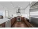 Contemporary kitchen with stainless appliances, modern cabinets, and wood floors at 110 N Corcoran St # 2304, Durham, NC 27701