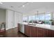Open kitchen with sleek appliances, a large island, and a view of the dining area at 110 N Corcoran St # 2304, Durham, NC 27701