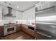 Modern kitchen featuring stainless steel appliances, white subway tile backsplash, and custom wood cabinets at 110 N Corcoran St # 2304, Durham, NC 27701