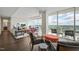Open living area with hardwood floors, multiple seating areas, and city views from floor-to-ceiling windows at 110 N Corcoran St # 2304, Durham, NC 27701