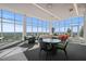 Spacious resident lounge boasting floor-to-ceiling windows with panoramic city views, complemented by stylish seating at 110 N Corcoran St # 2304, Durham, NC 27701