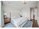 Bedroom featuring an upholstered bed, side tables, and area rug, with an ensuite door visible in the background at 110 N Corcoran St # 2304, Durham, NC 27701