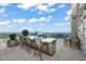 Outdoor kitchen with a built-in BBQ grill and bar seating, ideal for rooftop entertaining with great views at 110 N Corcoran St # 2304, Durham, NC 27701