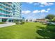 Relax on the amenity deck featuring a large turf area, an outdoor kitchen, and a lounge space at 110 N Corcoran St # 2304, Durham, NC 27701