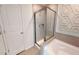 Contemporary bathroom showcasing glass-enclosed shower, white soaking tub, and decorative wall panel at 1105 Freestone Rd, Durham, NC 27703