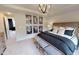 Beautiful bedroom with a bed dressed with black and beige pillows and striped bench at the foot of the bed at 1105 Freestone Rd, Durham, NC 27703