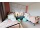 Charming bedroom with two beds, floral wallpaper, and aqua accessories, creating a serene ambiance at 1105 Freestone Rd, Durham, NC 27703