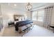 Serene bedroom with tray ceiling, large window, and elegant decor at 1105 Freestone Rd, Durham, NC 27703