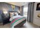 Fun bedroom with a galaxy wall and bed with striped bedding set near a window with gray curtains at 1105 Freestone Rd, Durham, NC 27703