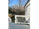 View from the backyard deck shows the fenced-in yard with trees at 1210 Shaw St, Burlington, NC 27217