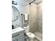 Updated bathroom featuring a new vanity, decorative mirror, and tiled walk-in shower at 1210 Shaw St, Burlington, NC 27217